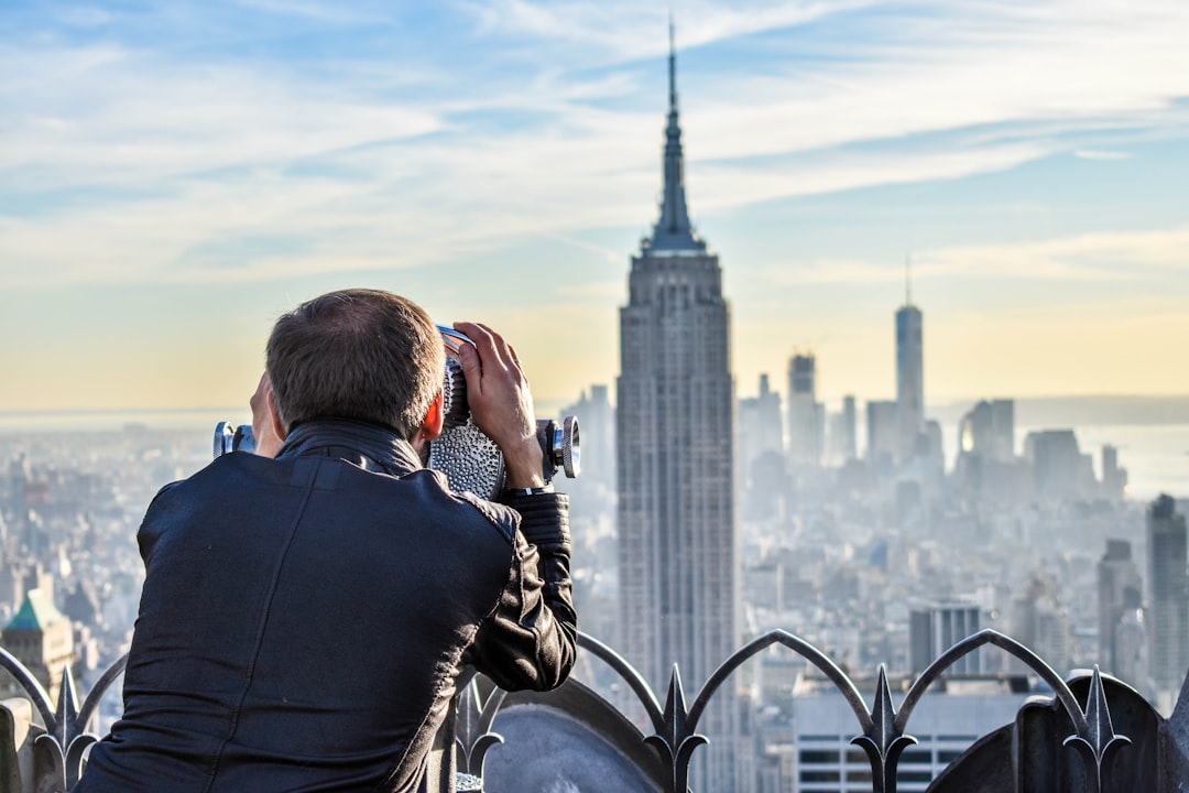 remote it jobs nyc professional working from home with New York City skyline - remote it jobs nyc